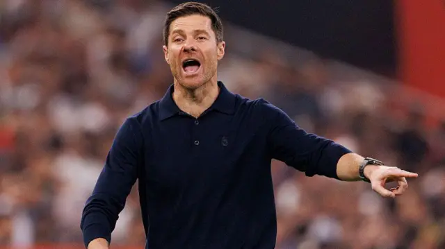 Xabi Alonso points on the touchline to his players