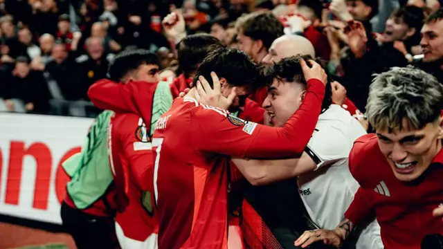 Manchester United players celebrate with supporters