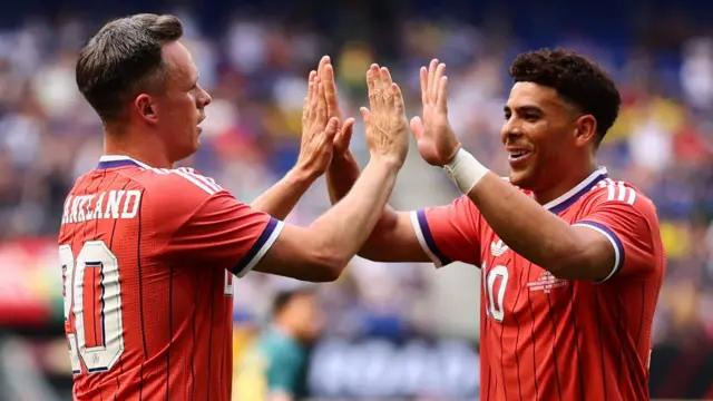 Scotland's Lawrence Shankland and Che Adams celebrate