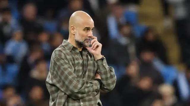Pep Guardiola looks on concerned during match