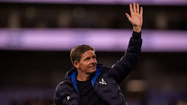 Oliver Glasner, wearing a dark-coloured Crystal Palace jacket, waves to supporters