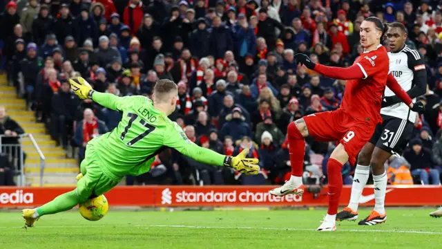 Bernd Leno makes a save from Darwin Nunez