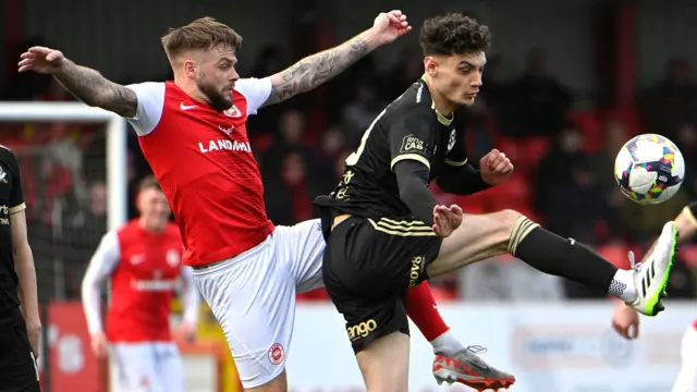 Larne's Andy Ryan battles with Crusaders' Lewis Barr at Inver Park in April