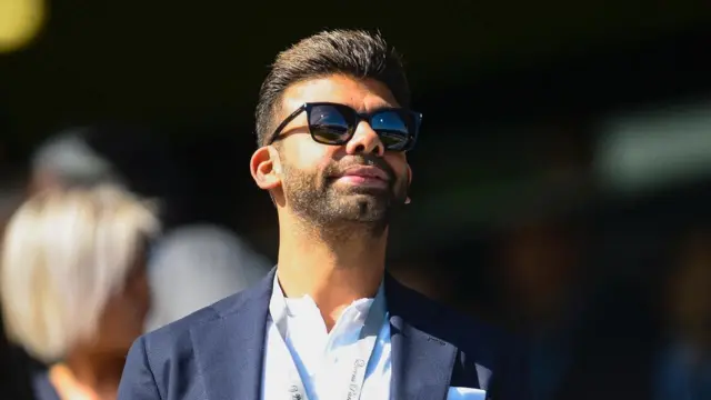 Amit Bhatia looks on from the Loftus Road directors' box during a Championship match