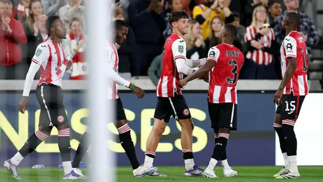 Aaron Hickey of Brentford celebrates scoring against Aston Villa