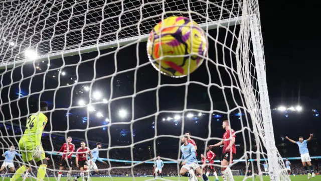 Josko Gvardiol of Manchester City beats Andre Onana of Manchester United to score their first goal during the Premier League match between Manchester City and Manchester United at Etihad Stadium.