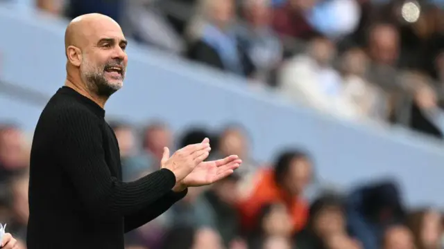 Manchester City's Spanish manager Pep Guardiola applauds