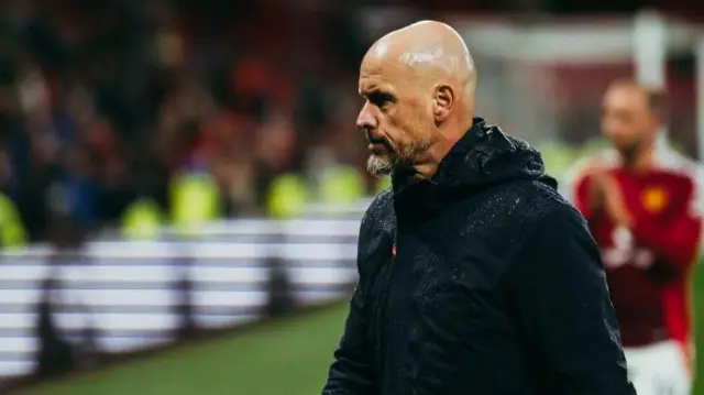 Manchester United manager Erik ten Hag walks off the Old Trafford pitch after the defeat by Tottenham on Sunday