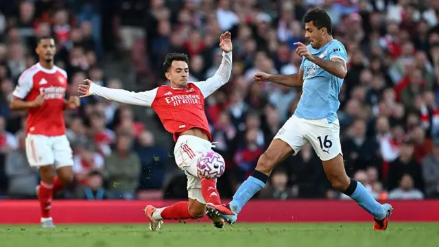 Rodri of Manchester City is challenged by Martin Zubimendi of Arsenal
