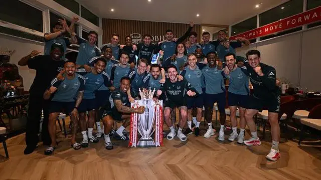 The Arsenal players celebrate winning the Premier League