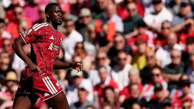 Ibrahima Konate with the Anfield crowd out of focus in the background