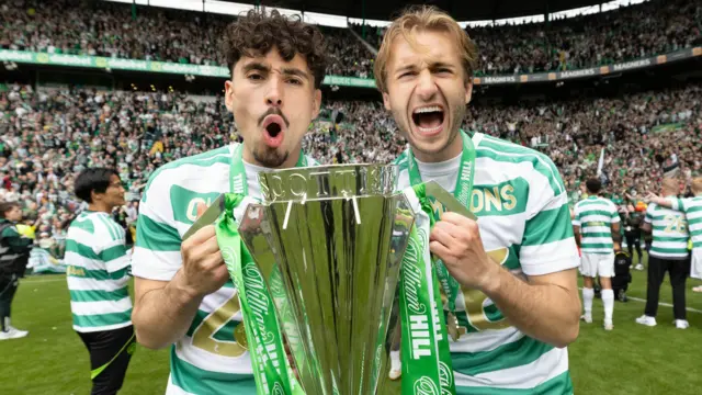 Celtic players celebrating with the Scottish Premiership trophy