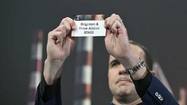 Special guest John O'Shea draws out the card of Brighton & Hove Albion during the UEFA Europa League 2023/24 Round of 16 Draw