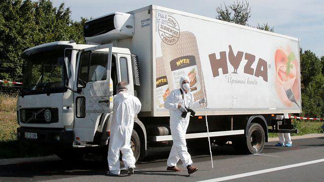 On a motorway near Parndorf, Austria, forensic police officers inspect the truck in which 71 migrants were found dead.