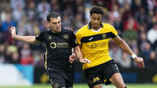 Oisin McEntee and Tete Yengi battle for possession