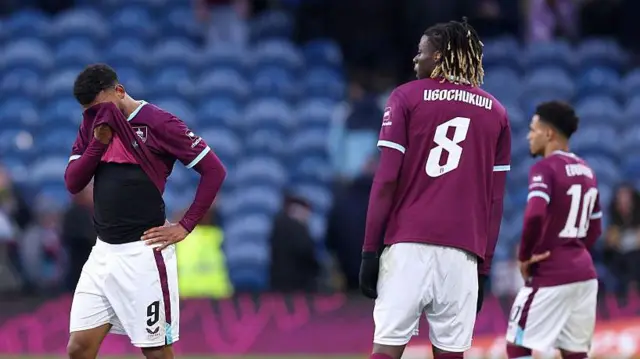 Burnley players look dejected after the defeat by Mansfield Town.