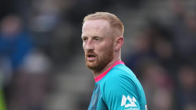 Liam Stanley during an away match last season for Harrogate, wearing a teal-coloured kit