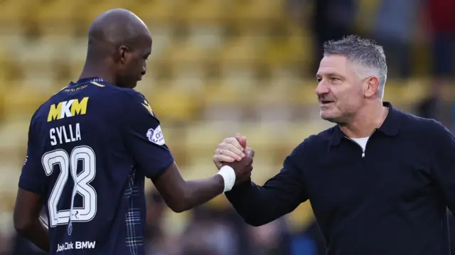 Mo Sylla and Tony Docherty shake hands