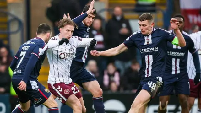 Dundee's Drey Wright, Callum Jones and Ethan Hamilton and Hearts' Jordi Altena in action during a William Hill Premiership match between Dundee and Heart of Midlothian at Dens Park