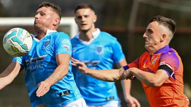 Linfield's Joel Cooper challenges Ballymena United's Ben Kennedy in the Irish Premiership game in August