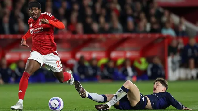 Anthony Elanga runs with the ball past a prone Alejandro Garnacho