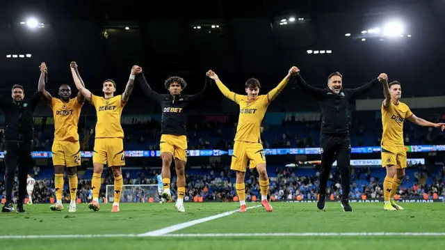 Wolves personnel in front of the travelling fans. 