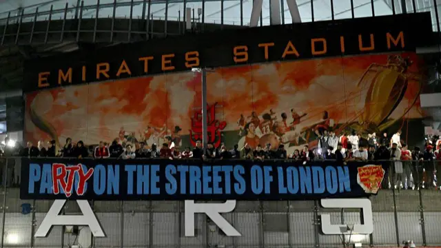 Arsenal fans celebrate their team winning the Premier League