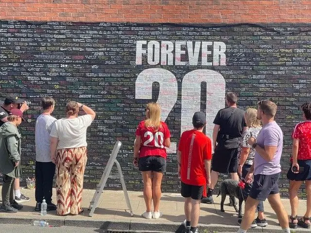 Fans gather at a 'Forever 20' mural dedicated to Diogo Jota