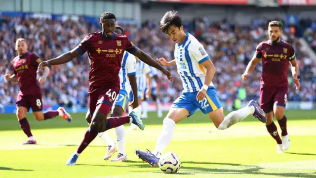 Kaoru Mitoma of Brighton is challenged by Axel Tuanzebe of Ipswich