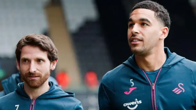 Joe Allen and Ben Cabango arrive at a Swansea game 