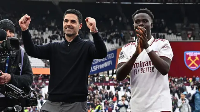 Mikel Arteta and Bukayo Saka celebrate in front of Arsenal fans