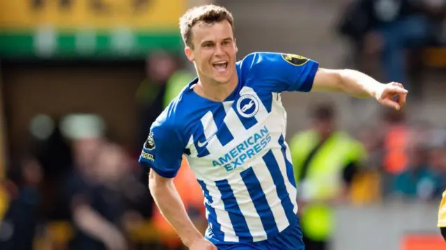 Solly March of Brighton celebrates scoring their side's third goal of the game