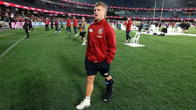 Darcy Graham walking around the pitch in a boot