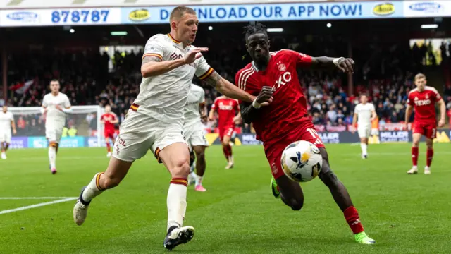 Aberdeen’s Pape Gueye  and Motherwell's Liam Gordon