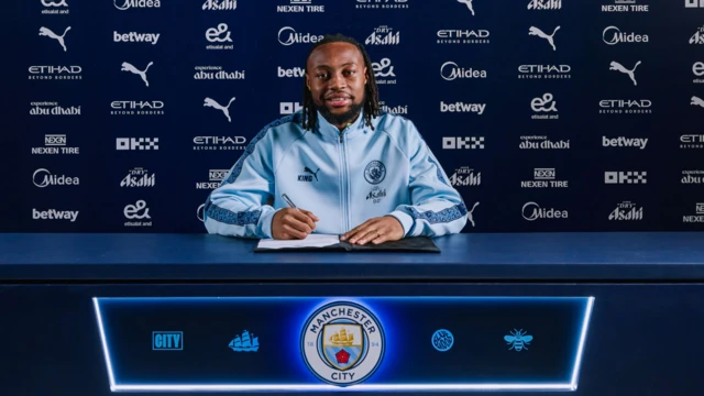 Antoine Semenyo with a pen signing on the contract