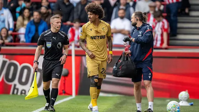 Chris Richards of Crystal Palace is helped off the pitch.
