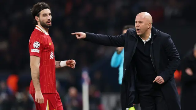 Arne Slot gestures from the touchline