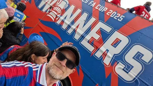 Crystal Palace fan in front of bus