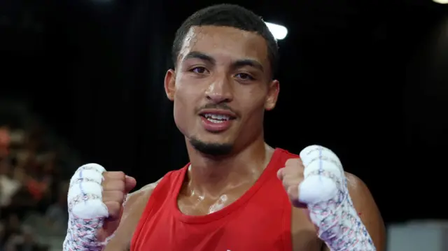 Orlando Holley-Sotomi posing with his fists up