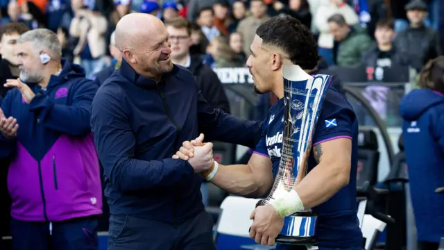 Gregor Townsend celebrates with Sione Tuipulotu