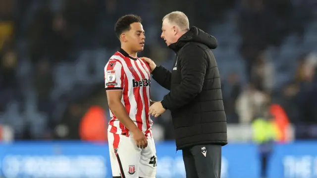 Stoke City boss Mark Robins speaking with Million Manhoef
