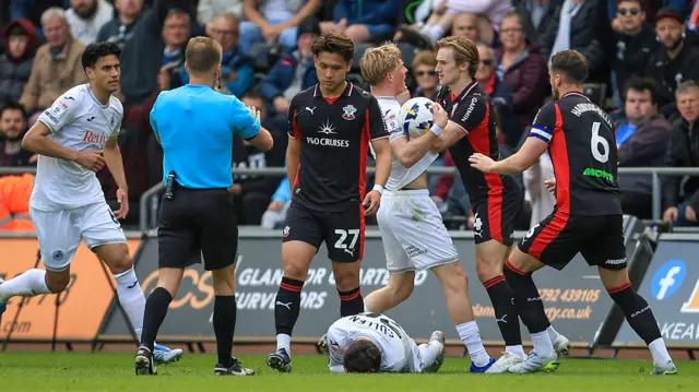 Flynn Downes clashes with Melker Widell with Liam Cullen on the ground 