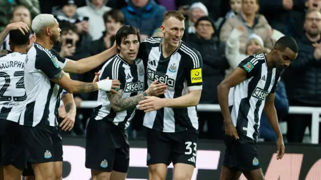 Joelinton, Sandro Tonali and Dan Burn of Newcastle United celebrate