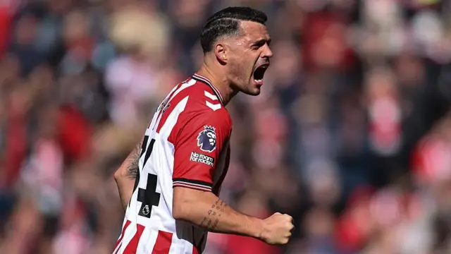 Granit Xhaka celebrates. Punching the air in Sunderland's home strip.