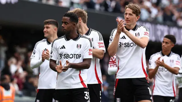 Fulham players applaud their fans