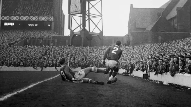 Jimmy Gabriel of Everton gives Gerry Byrne a kick