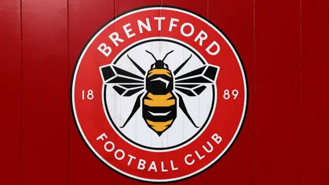 Brentford badge on red, paneled wood