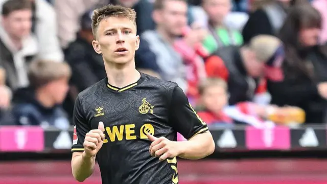 Kristoffer Lund in action for Bundesliga club FC Cologne. He is wearing a black away shirt.