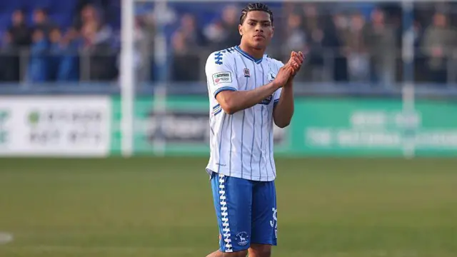 Calvin Okike of Hartlepool United applauds fans
