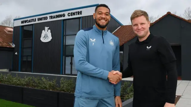 Joelinton shakes hands with Eddie Howe